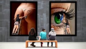 Vibrant art installation in Cozumel, Mexico, featuring close-up portraits of a woman’s eye and a woman’s lower back with tattoo, showcasing the island’s artistic culture and unique gallery experiences.