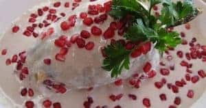 Chiles en Nogada in creamy pomegranate sauce garnished with fresh parsley, served in Cozumel Mexico vacation rental near Stingray Villa.