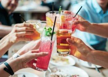 Colorful cocktails being raised in a toast at a vacation dinner in Cozumel, Mexico, near Stingray Villa. Perfect for relaxing and enjoying the vibrant tropical atmosphere of the Caribbean destination.
