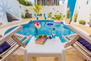 Luxurious pool at Stingray Villa in Cozumel Mexico, with tropical decor, loungers, and vibrant plants, perfect for a relaxing vacation rental by the sea.