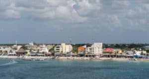 Colorful coastal town in Cozumel, Mexico, showcasing waterfront buildings, boats, and vibrant streets near Stingray Villa vacation rental. Perfect for relaxing island getaway.