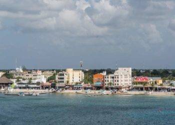 Colorful coastal town in Cozumel, Mexico, showcasing waterfront buildings, boats, and vibrant streets near Stingray Villa vacation rental. Perfect for relaxing island getaway.