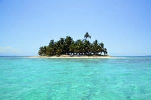 Secluded tropical island in Cozumel Mexico with lush palm trees and clear turquoise waters. Ideal for relaxing beach holidays and island adventures.
