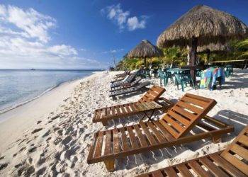 Sunset Beach Chairs and Tiki Huts near Stingray Villa, Cozumel, Mexico - Perfect for relaxing vacations.