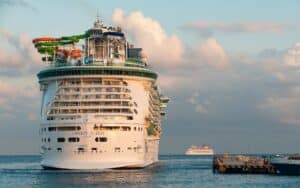 Luxury cruise ship Liberty of the Seas docked in Cozumel, Mexico, with vibrant water slides on deck, representing a perfect vacation destination.