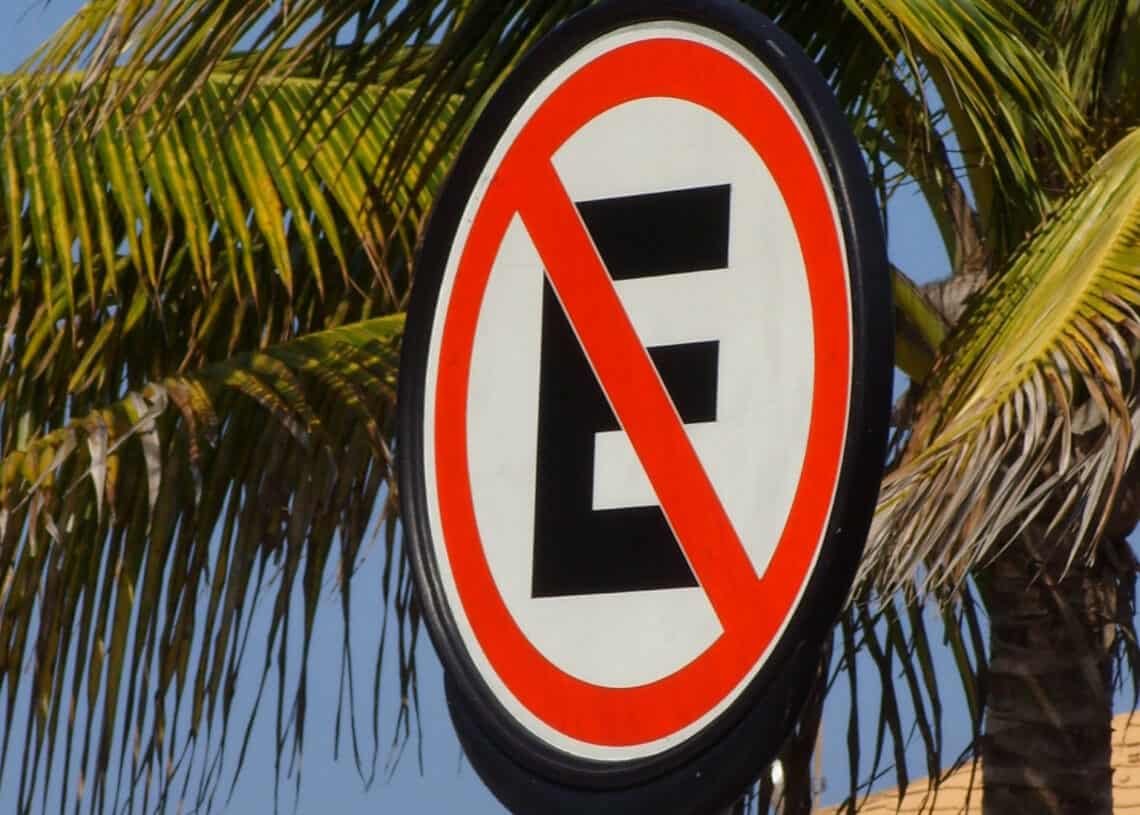 No parking sign on Cozumel Mexico beach street near Stingray Villa, tropical palm trees, clear skies, travel destination, vacation rental, Caribbean island.