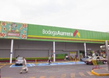Brightly colored Bodega Aurrera supermarket exterior in Cozumel, Mexico, with shopping carts and customers, offering easy access for vacationers staying at Stingray Villa.