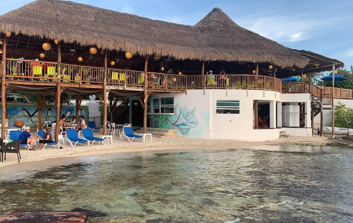 Vibrant beachfront bar La Monina in Cozumel, Mexico, with ocean views and tropical decor, perfect for relaxing vacation stays.