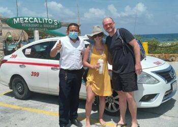 Alex the Cozumel taxi tour at Cozumel, Mexico with tourists enjoying the beach, featuring a taxi, ocean views, and local dining spots like Mezcalito's.