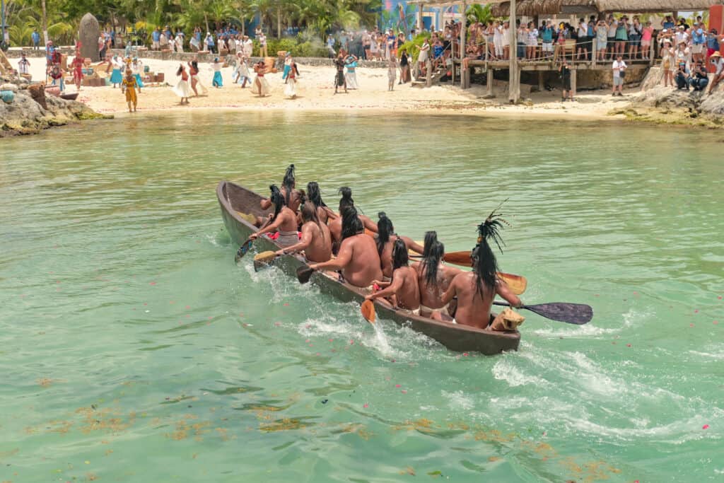 Traditional Mayan canoe race in Cozumel, Mexico near Stingray Villa, with cultural performances and scenic beach views.