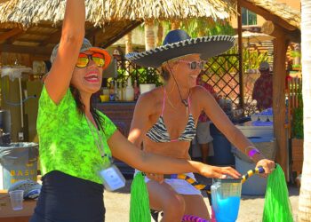 Colorful women enjoying a sunny day at Cozumel Mexico, with tropical decor and beach accessories, perfect for a relaxing vacation in the best vacation rental.