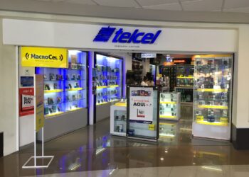Modern cellphone store at Cozumel Mexico supermarket, showcasing a variety of smartphones and accessories, perfect for travelers looking for tech gear during their vacation at Stingray Villa.
