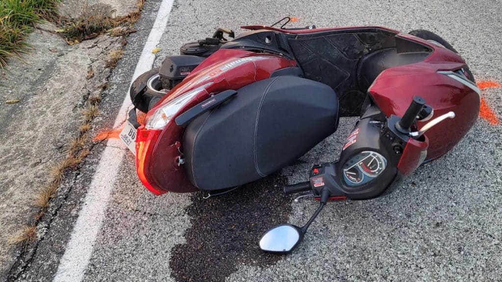 Motorcycle wreck on Cozumel Mexico street near Stingray Villa vacation rental, showing a red scooter with side mirror and dashboard, emphasizing travel safety and local transportation.
