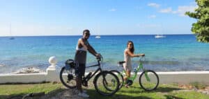 Sunset Ride in Cozumel Mexico at Stingray Villa vacation rental with friends cycling along the beach. Enjoy ocean views and tropical scenery, perfect for a relaxing getaway.