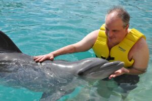 Dolphin encounter at Cozumel, enjoying a close interaction with the friendly dolphin in clear turquoise waters.