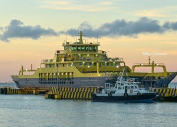 Large yellow ferry boat docked at the pier during sunset in Cozumel, Mexico