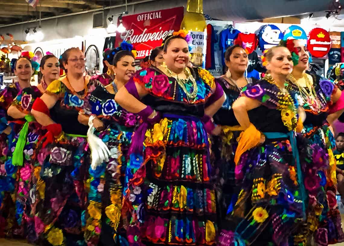Colorful traditional Mexican dancers performing in Cozumel, Mexico, during cultural festivities near Stingray Villa vacation rental. Experience authentic Mexican culture, vibrant costumes, and local traditions.