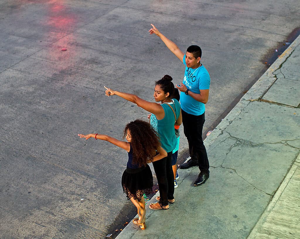 Hailing a taxi in Cozumel Mexico, near Stingray Villa vacation rental. Scenic coastal atmosphere with colorful reflections on the pavement.